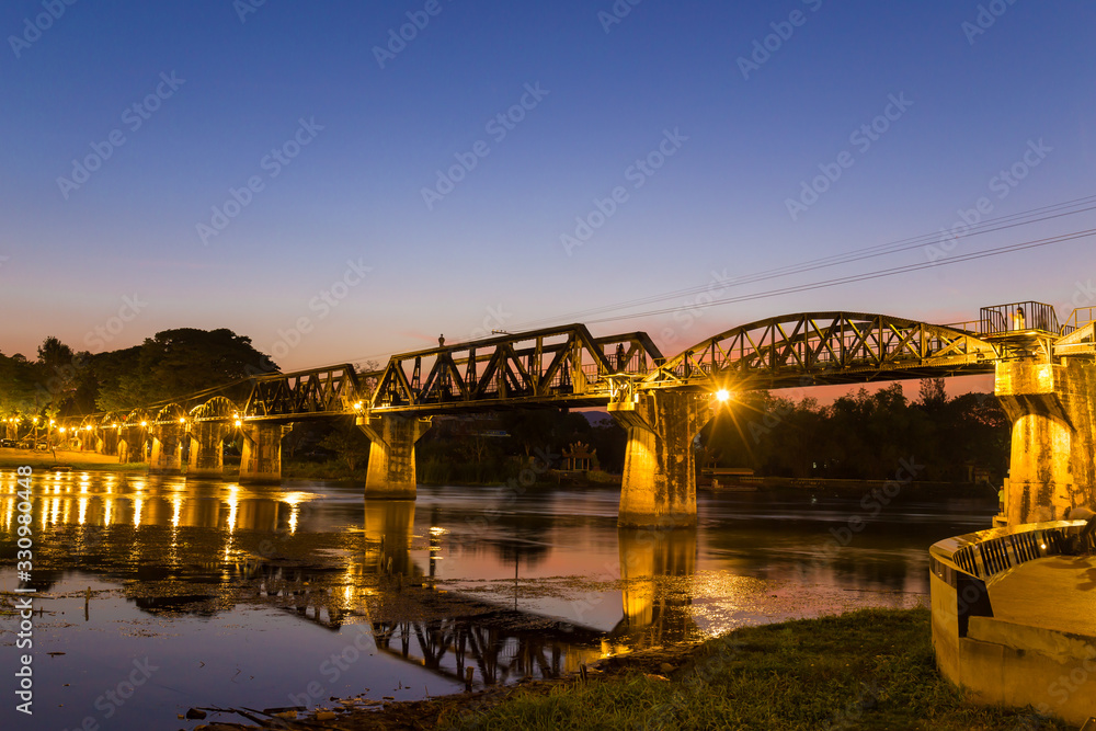 The Bridge on the River Kwai Built during World War II. Is an important place and a destination for tourists from around the world. Twilight time The Bridge on the River Kwai Built during World War II. Is an important place and a destination for tourists from around the world. Twilight time