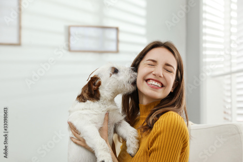 Fotografija Young woman with her cute Jack Russell Terrier at home