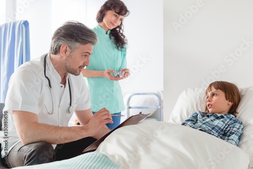 Pediatrician visiting a patient photo