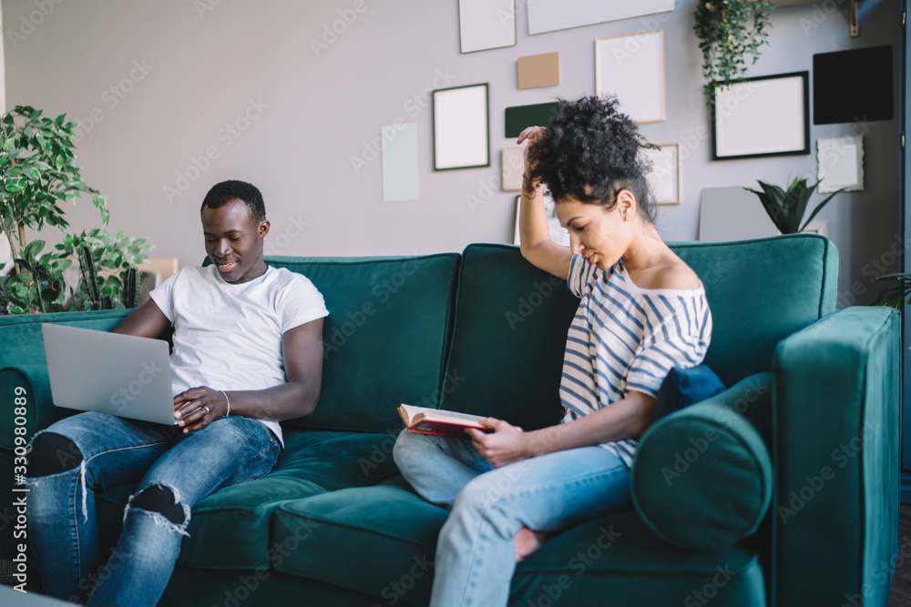 Multiethnic couple spending free time at home Multiethnic couple spending free time at home