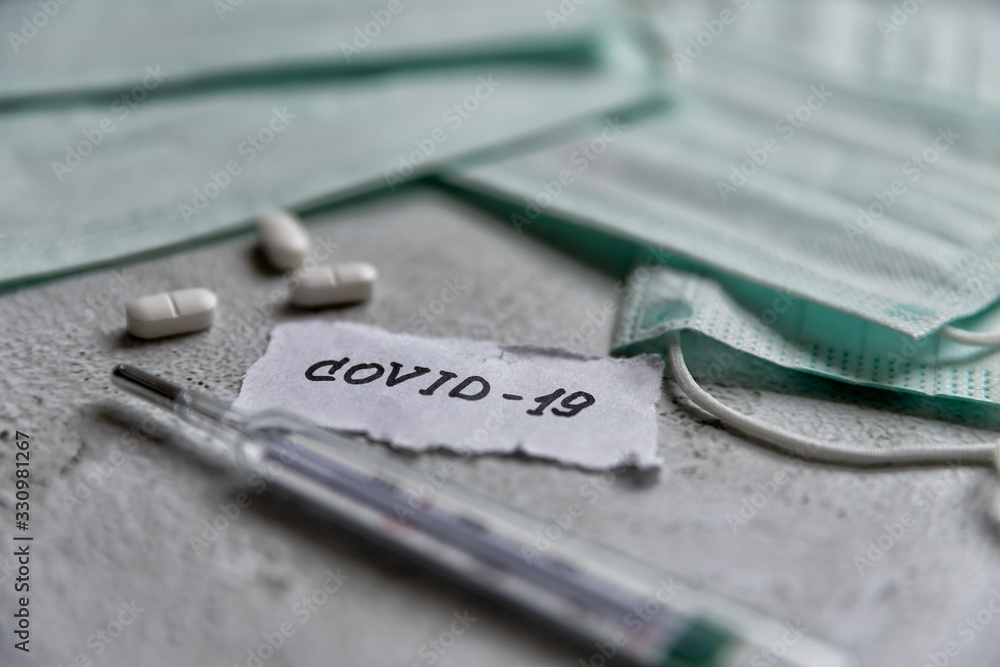 Coronavirus covid-19 quarantine pills, medical mask and thermometer