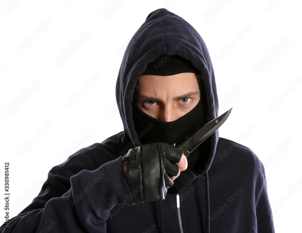 Man in mask with knife on white background. Dangerous criminal