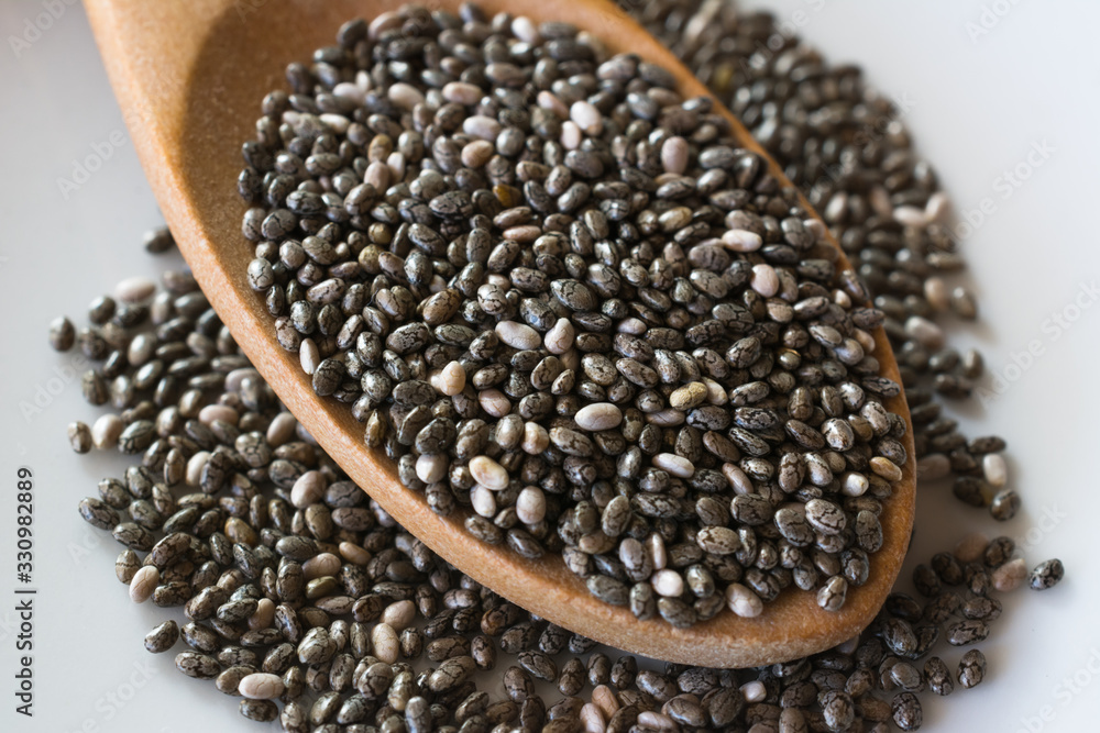 Chia seeds in a wooden spoon close up. Chia seeds in a wooden spoon close up.