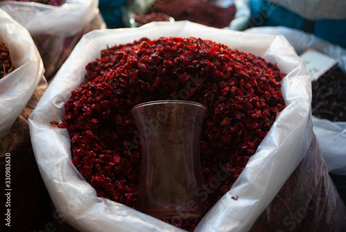 Close-up of bag with Sumac in a local street market in the village. Dried herbs and spices shop. Herbs for medical treatment. Exploring villages of Azerbaijan photo