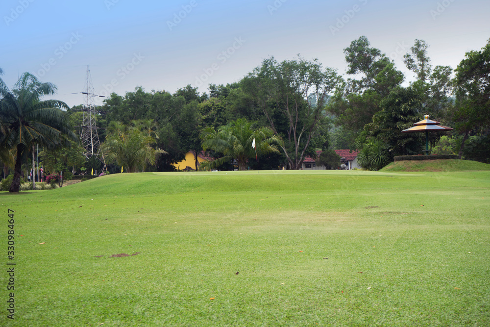 The evening golf course has sunlight shining down at golf course in Thailand The evening golf course has sunlight shining down at golf course in Thailand