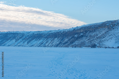 winter scenery , frozen lake covered by snow