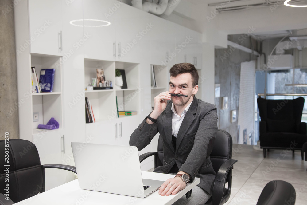 young businessman works in an office with a laptop young businessman works in an office with a laptop