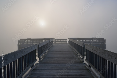 Φωτογραφία Landscape of dock in fog at sunrise, Whitford Lake, Fort Custer State Park, Mich