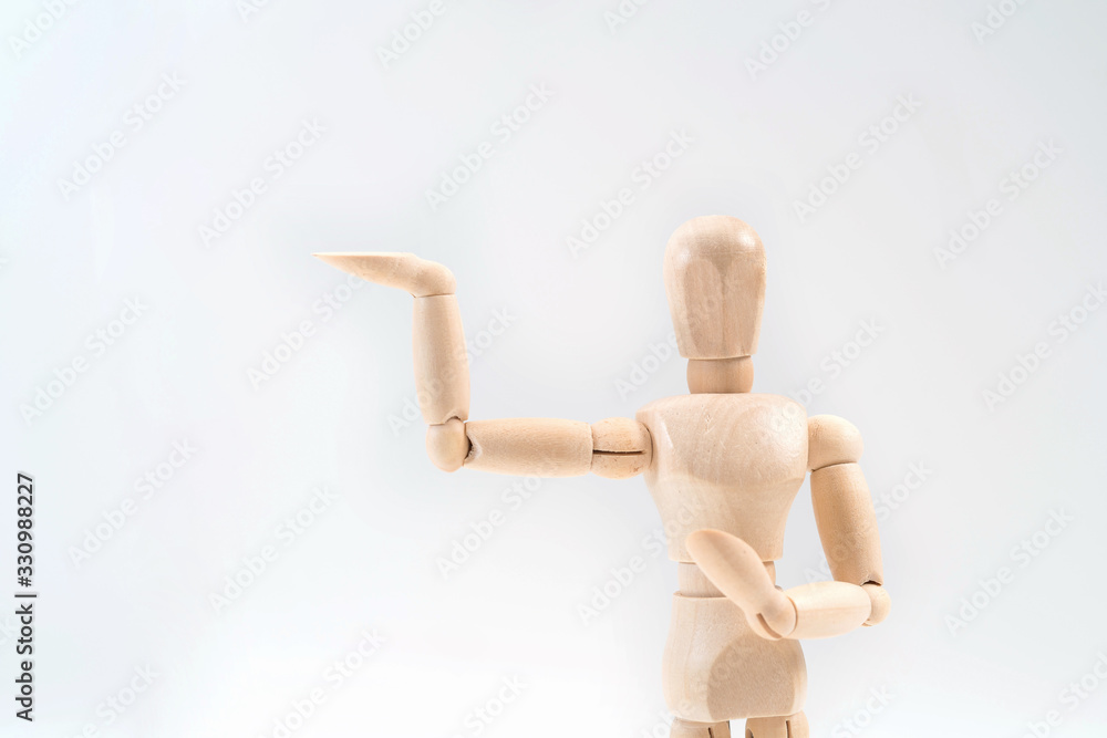 Wooden dummy proudly presents some invisible thing, isolated on white background, copy space for your object or text Wooden dummy proudly presents some invisible thing, isolated on white background, copy space for your object or text