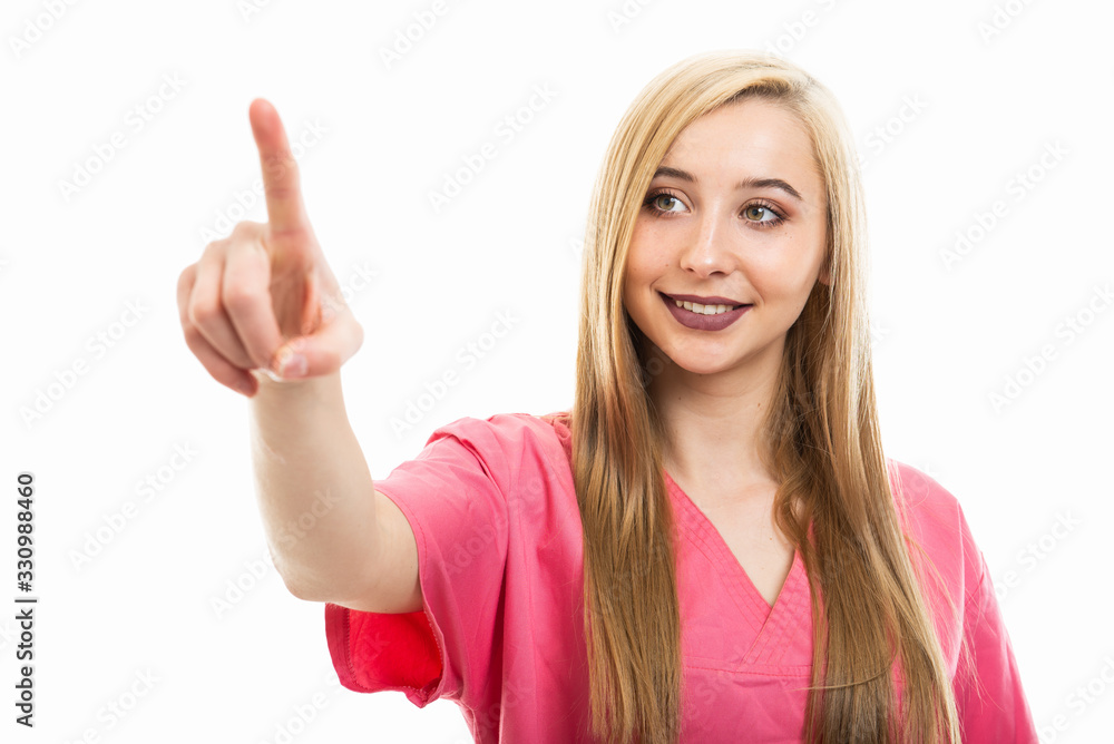 Portrait of cute young female nurse wearing scrubs using touchscreen Portrait of cute young female nurse wearing scrubs using touchscreen