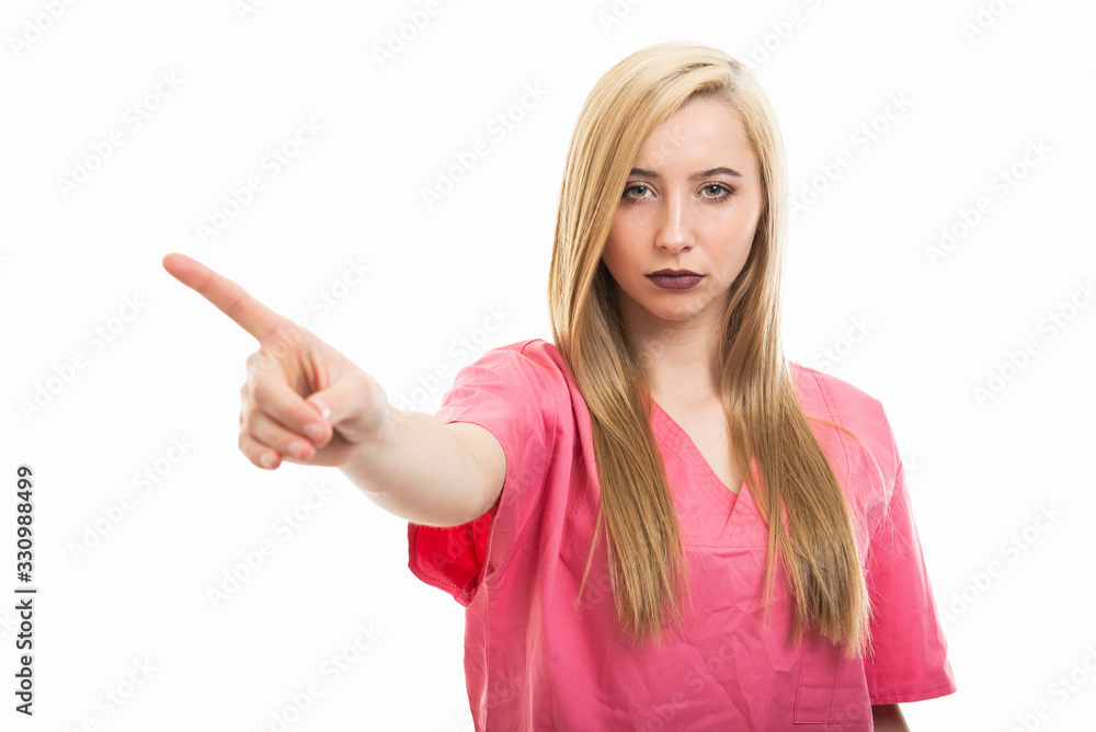 Portrait of young female nurse wearing scrubs showing denial
