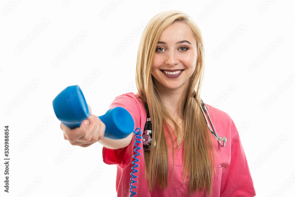 Portrait of female nurse wearing scrubs handing blue receiver smiling Portrait of female nurse wearing scrubs handing blue receiver smiling