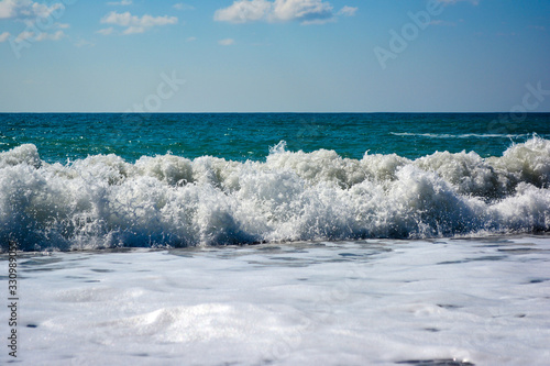 sea wave with foam and blue sky