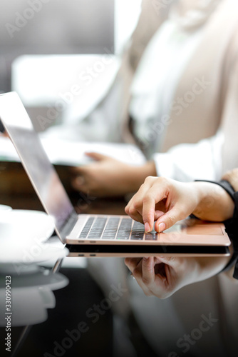 Businesswoman with a laptop on her desk discussing business