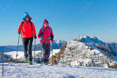 A pair of female friends during a snow hike