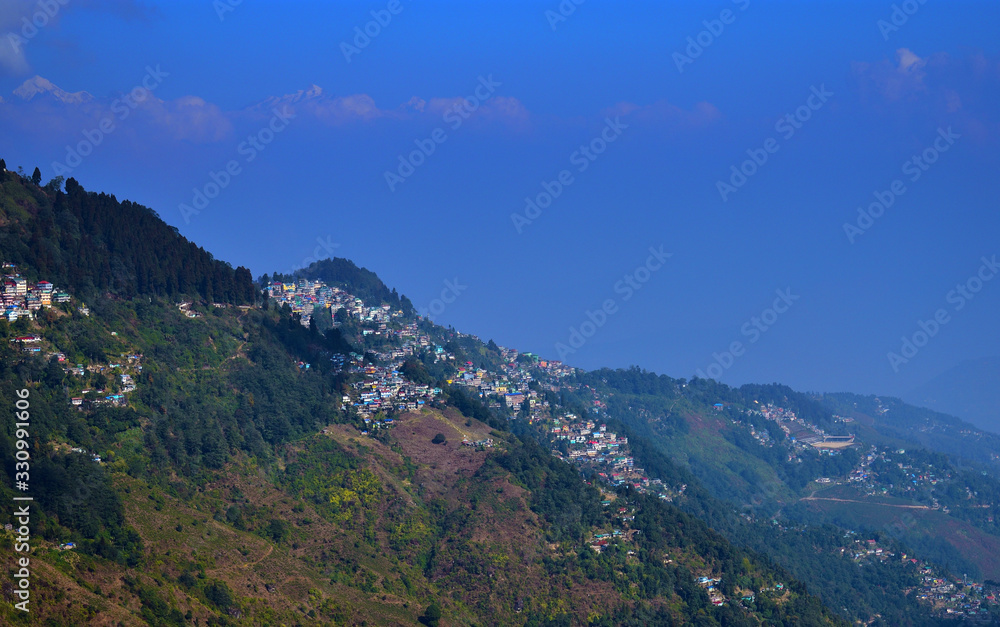 View across downtown of Darjeeling towards the dramatic mountain range of Kanchenjunga