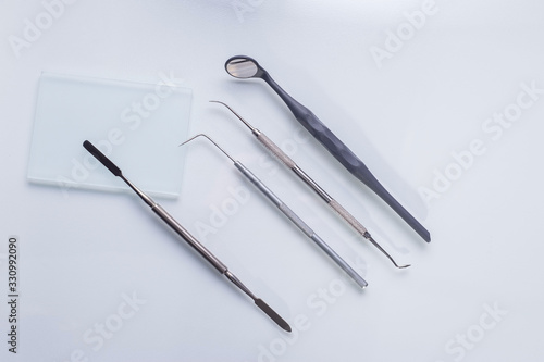top view, medical dental instruments, on a sterile subject table of a dentist doctor. Near the dummy of human jaws and teeth. Medical Flatlay