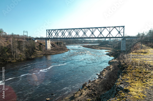 Railway bridge over the river. Sunny spring day. The border of Ivangorod Narva. Russia Estonia