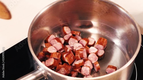 A close-up of sliced sausages from a bowl.