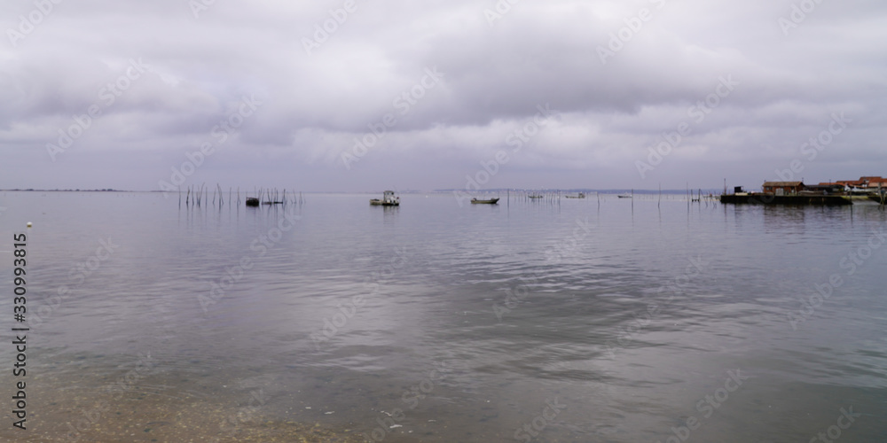 Lège-Cap-Ferret water boats reflection sky cloud in sea bay arcachon basin France
