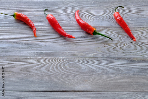 Fresh red hot chili peppers on a wooden table