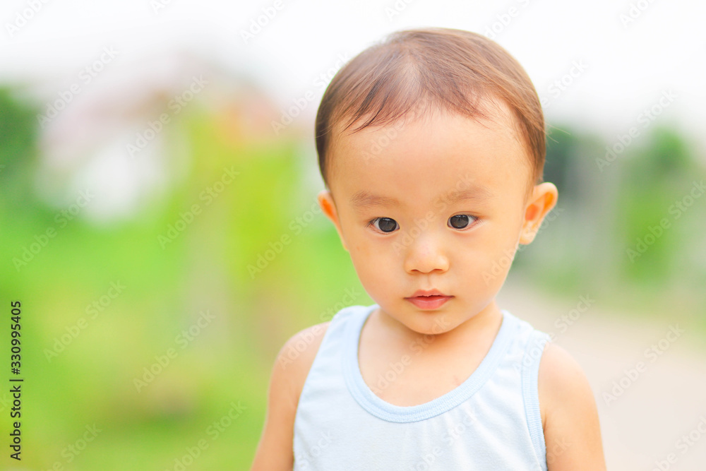 Close up outdoor shot of little adorable Asian boy Close up outdoor shot of little adorable Asian boy