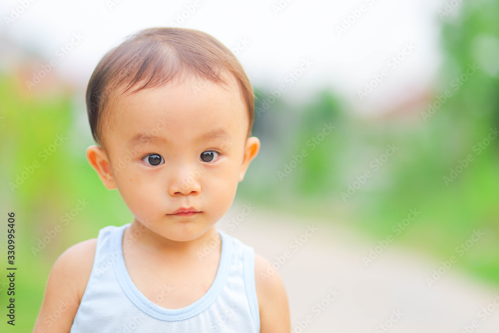 Close up outdoor shot of little adorable Asian boy Close up outdoor shot of little adorable Asian boy