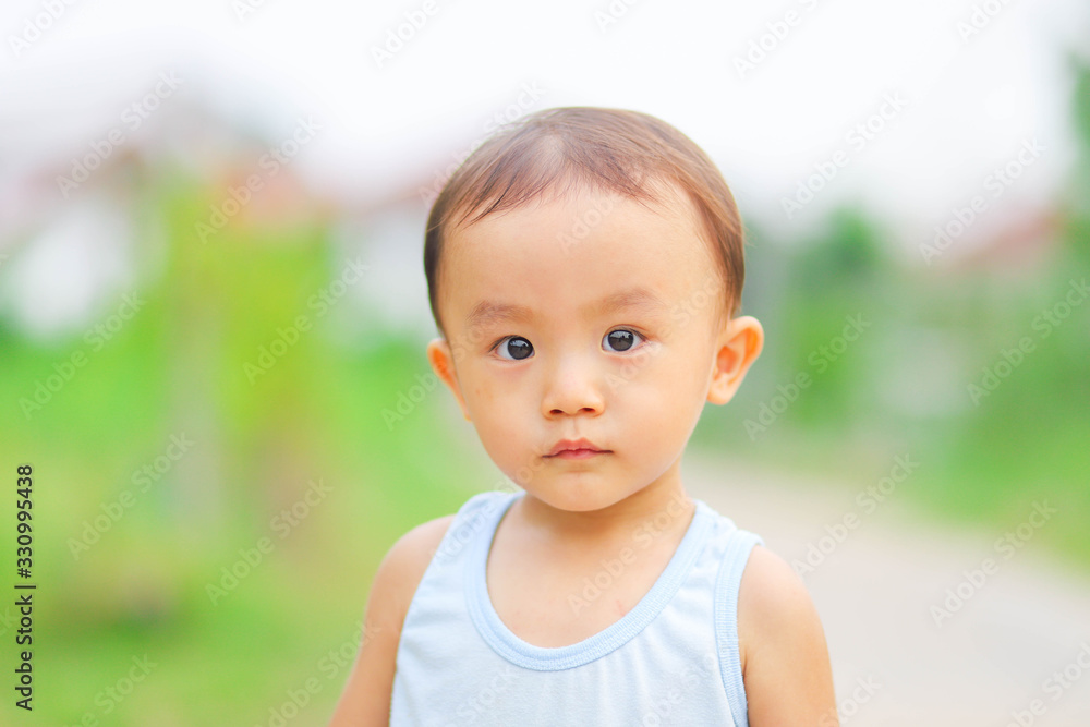 Close up outdoor shot of little adorable Asian boy Close up outdoor shot of little adorable Asian boy