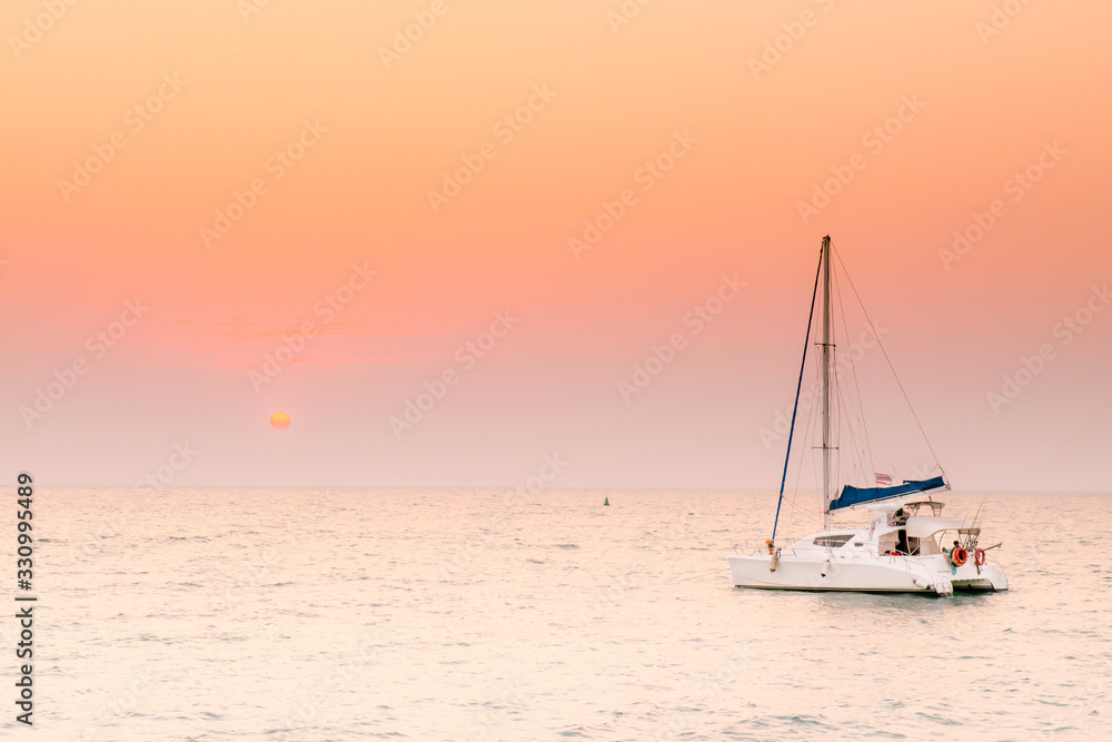 Colorful twilight with yacht, Impressionism image of seascape with sunset background, Beautiful sky during sunset and yacht, sail on sea. The beauty of the evening sky.