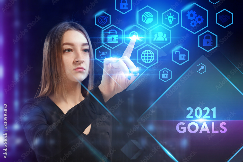 Business, Technology, Internet and network concept. Young businessman working on a virtual screen of the future and sees the inscription: 2021 goals