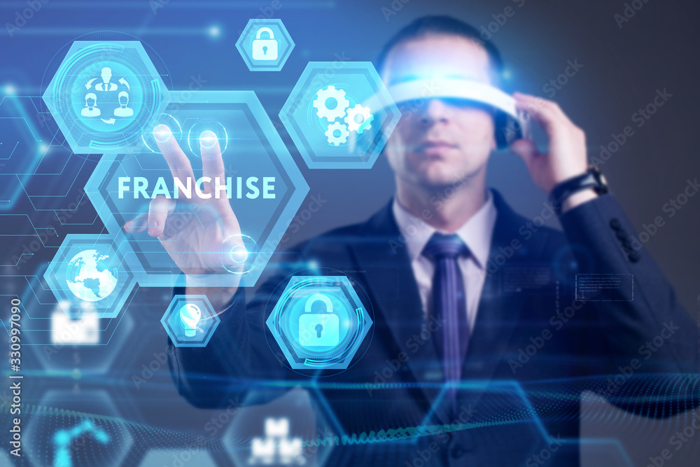 Business, Technology, Internet and network concept. Young businessman working on a virtual screen of the future and sees the inscription: Business, Technology, Internet and network concept. Young businessman working on a virtual screen of the future and sees the inscription: