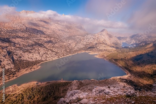 Puig Major with Cuber and Gorg Blau reservoirs, sun and blue skies with low white clouds, Tramuntana, Mallorca, Spain