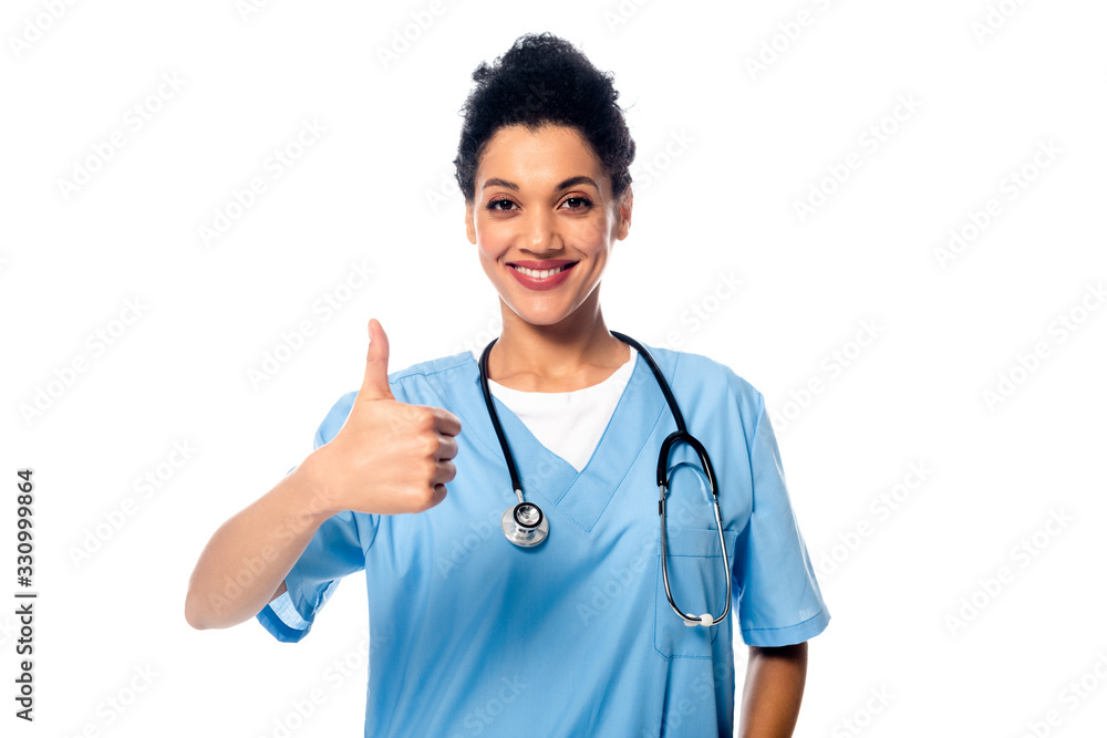 Front view of african american nurse with thumb up smiling isolated on white Front view of african american nurse with thumb up smiling isolated on white