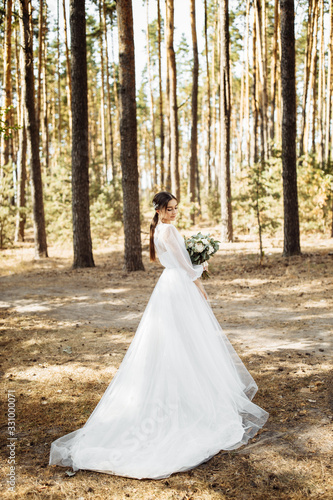 Attractive bride in the autumn forest 