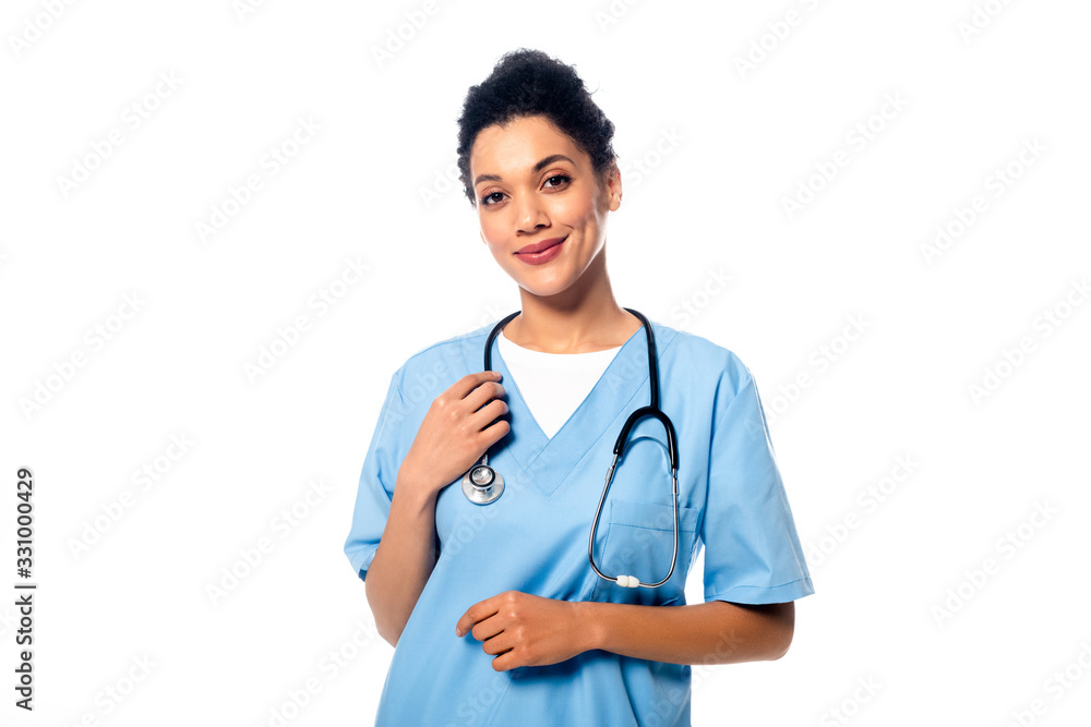 Front view of african american nurse with stethoscope smiling and looking at camera isolated on white Front view of african american nurse with stethoscope smiling and looking at camera isolated on white
