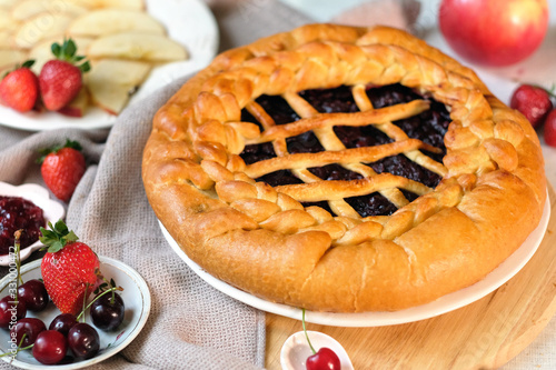 Round closed homemade baked pie with lingonberry photo