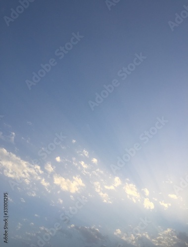 blue sky with clouds and sun