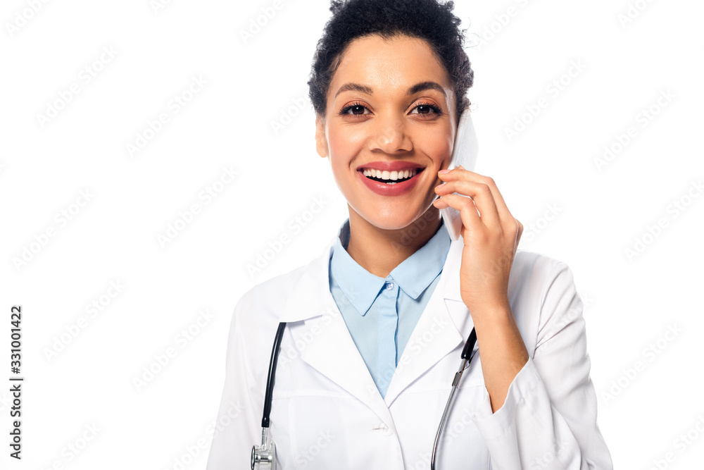 Front view of happy african american doctor with stethoscope talking on smartphone isolated on white Front view of happy african american doctor with stethoscope talking on smartphone isolated on white