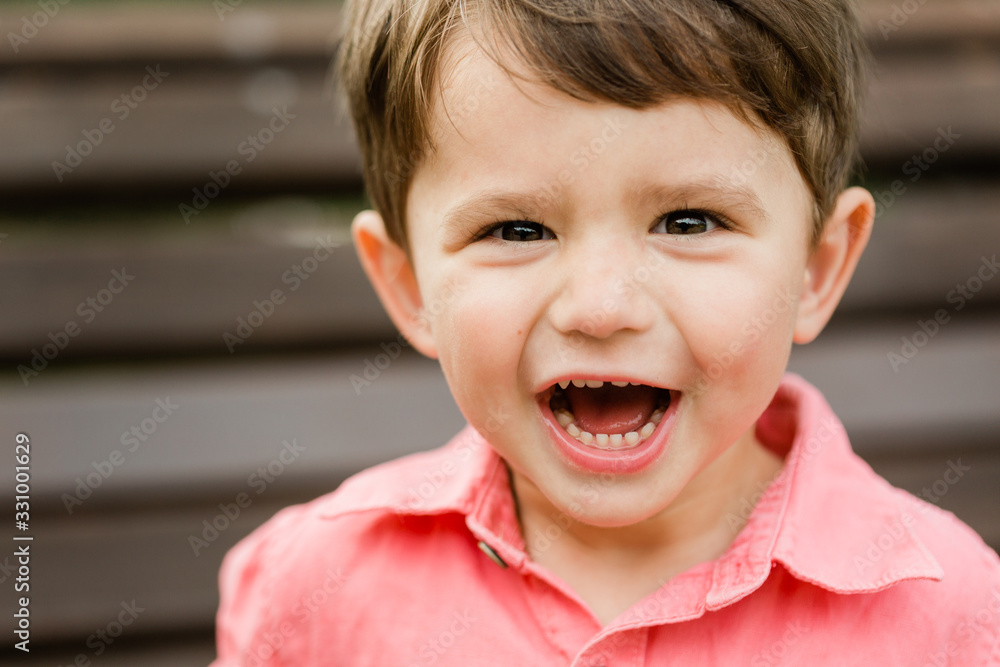 Closeup portrait of little cheerful boy. Happy laughing child Closeup portrait of little cheerful boy. Happy laughing child