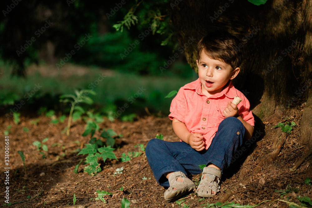Cute little boy having fun in summer park. Happy child outdoors Cute little boy having fun in summer park. Happy child outdoors