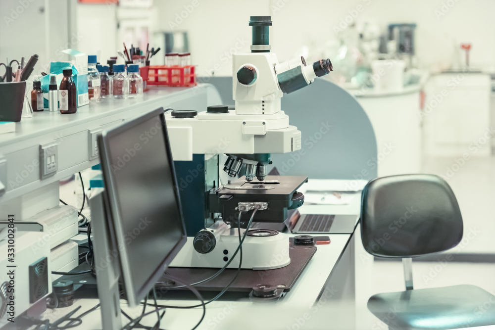 Microscope with metal lens at laboratory for developing vaccines against coronavirus Microscope with metal lens at laboratory for developing vaccines against coronavirus