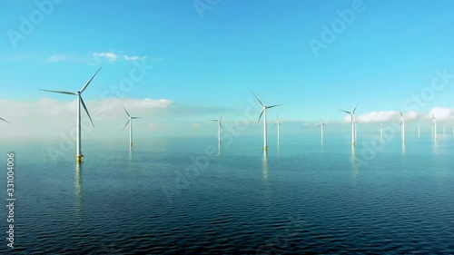 Windmill row of windmills in the ocean by the lake Ijsselmeer Netherlands, renewable energy windmill farm Flevoland