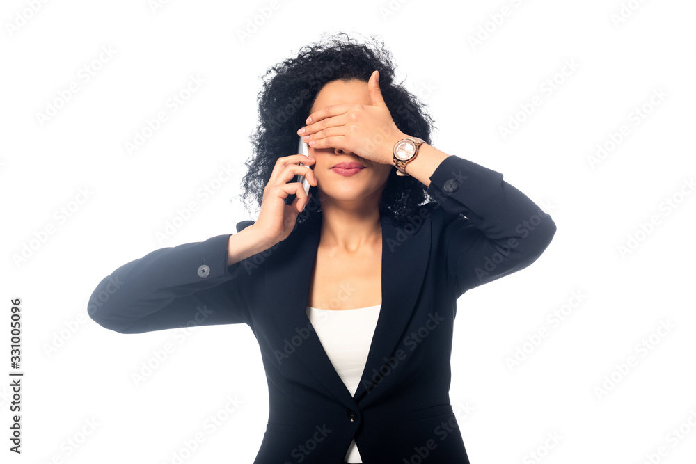 Front view of african american woman talking on smartphone and covering face isolated on white Front view of african american woman talking on smartphone and covering face isolated on white