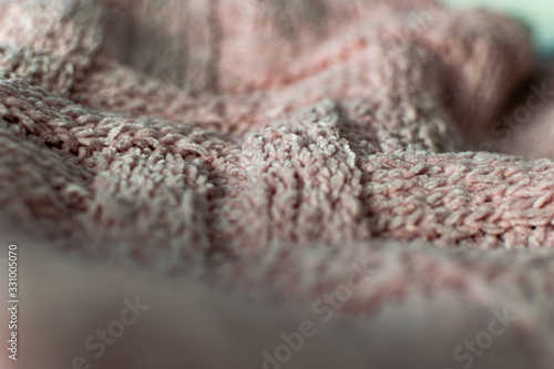 Fine textured and voluminous fabric in pink. Embossed textile pattern, pleasant to the touch and delicate, velvety and textured background for design and decoration.