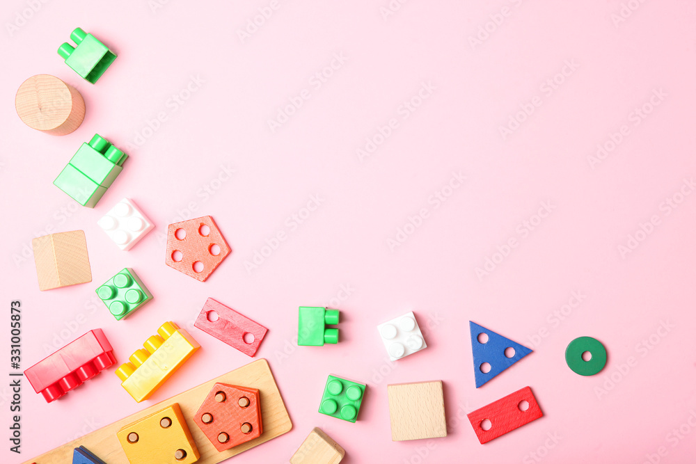 Set of different children's toys on a colored background top view. A place to insert text, minimalism. Baby background. Set of different children's toys on a colored background top view. A place to insert text, minimalism. Baby background.