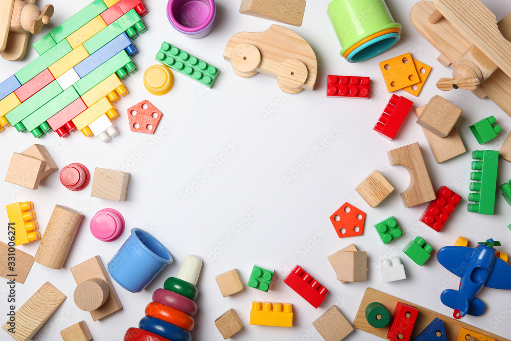 Naklejka premium Set of different children's toys on a colored background top view. A place to insert text, minimalism. Baby background.