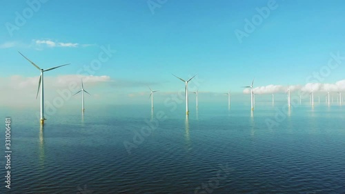 Windmill row of windmills in the ocean by the lake Ijsselmeer Netherlands, renewable energy windmill farm Flevoland