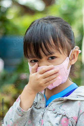 Asian child girl wearing a mask protect coronavirus 2019 (COVID-19) and PM 2.5 dust.