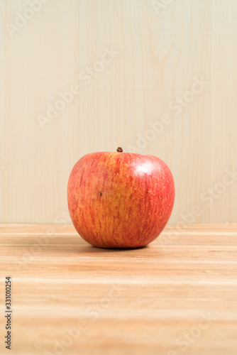 Red apple isolated on wood table. Apple Clipping Path