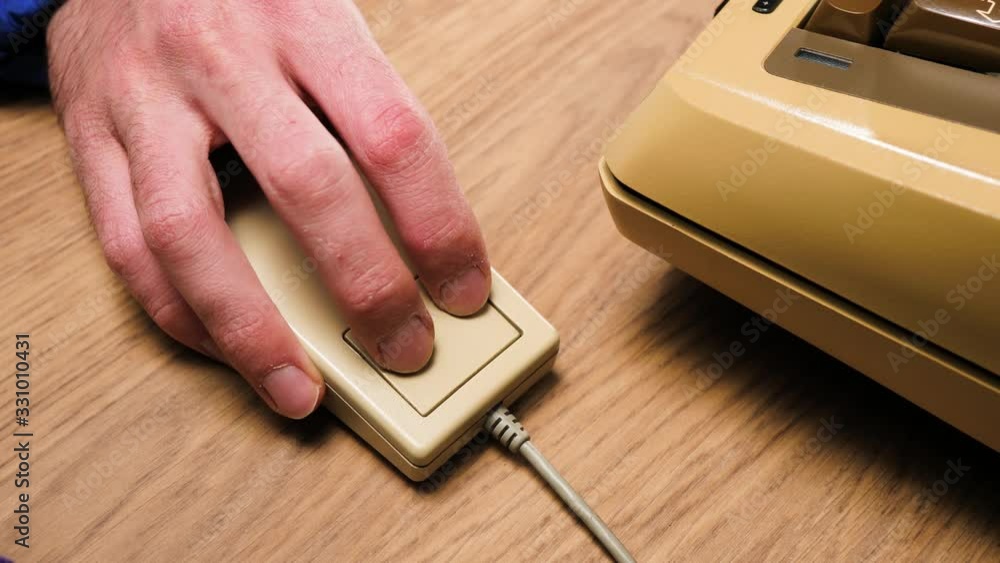 A hand using a retro computer mouse from the 70s 80s moving around on a ...